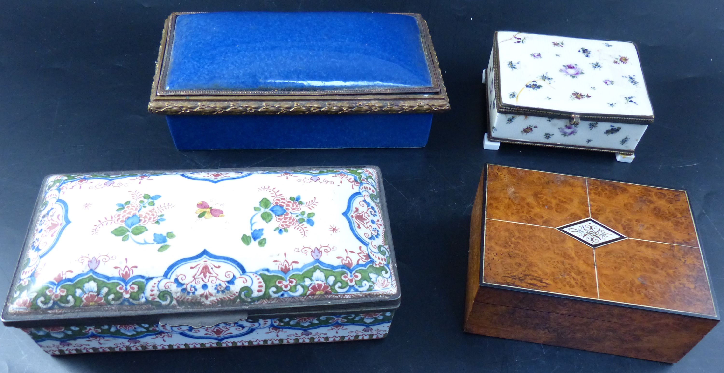 A burr wood cigarette box and three ormolu mounted ceramic caskets, largest 20cm